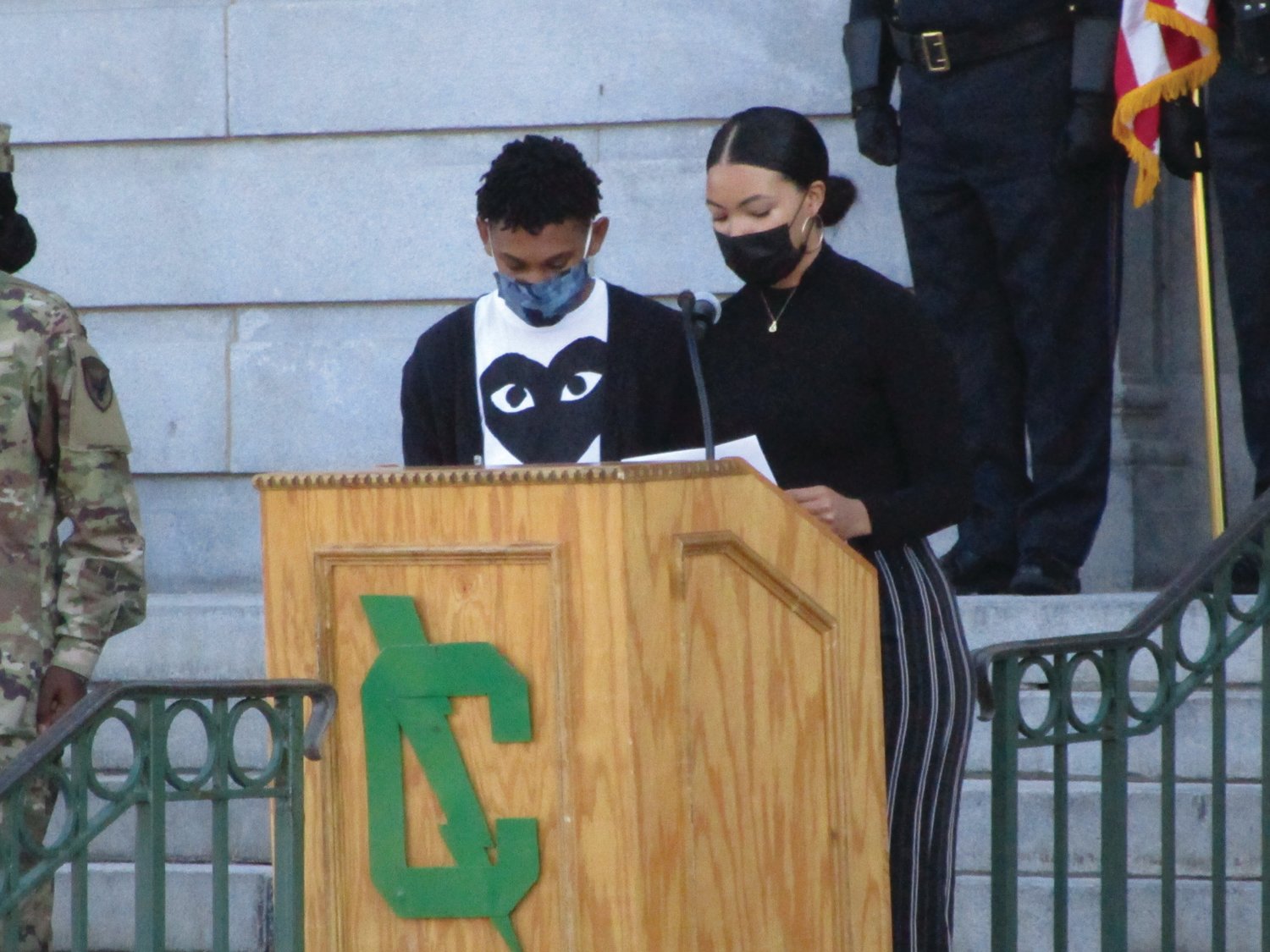 FROM THE HEART: Cranston East students Dashira Agramonte Diaz and Karon Ives read a poem during the ceremony.
